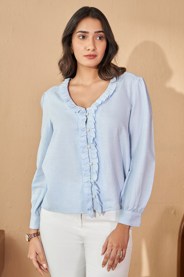 Pastel blue cotton top in v neck with frill.
