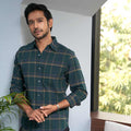 model wearing pink supply's madras checks shirt in green full sleeves