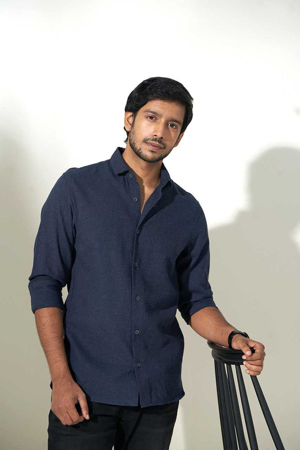 model wearing dark blue sustainable heather shirt with black pants