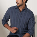 model wearing grey striped cotton woven shirt for men